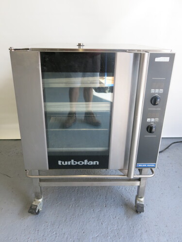 Blue Seal Electric Turbo Fan Oven on Mobile Stand, Model, S/N 479135. Comes with 4 Large Trays & 2 Small Trays. Size H101cm x W74cm x D81cm.