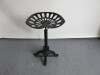 Cast Metal Stool with Tractor Style Seat with Adjustable Height & Foot Rest.