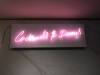 Cocktails & Dreams, Designed by Kerry Adams Soft Pink Neon Glass Sign on White Powder Coated Aluminum Mount. Size (H) 45 x (W) 138cm.