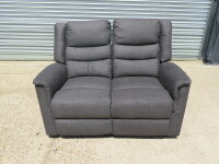 Parma Loveseat Grey Fabric 2 Seater Recliner Sofa. Size H96 x W135 x D80cm. Ex Display. Note: small tear to fabric on cushion back.