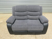 Chicago Grey Fabric & Black Premium Aire Leather 2 Seater Recliner Sofa. Size H96 x W145 x D84cm. New/Ex Display. RRP &pound;699.00. NOTE: scuff to corner.