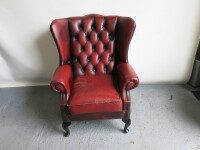 Ox Blood Leather Wing Back Arm Chair with Button Back Detail. Size H100 x W80 x D85cm.