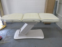 REM Excel Electric 3 Motor Beauticians Adjustable Treatment Chair/Couch Upholstered in White Vinyl and Comes with Controller, S/N 000182. NOTE: condition as viewed/pictured.
