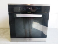 Miele Integrated Pureline Single Electric Oven, Model H6460BP, S/N BPBK6010. Size H60cm x W60cm x D56cm. NOTE: requires shelves & unable to power up (A/F sold for spares/repair).