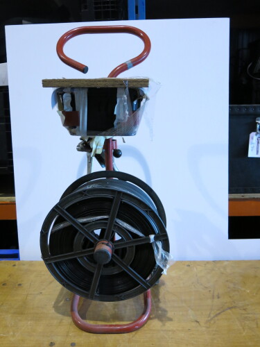 Band Strapping Machine with Reel of Band on Trolley.