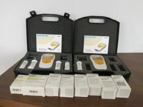 2 x Cobas Accutrend Plus Readers with Manuals, Carry Cases & Quantity of Test Strips.