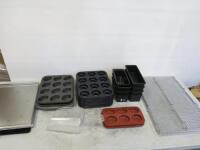 Assorted Lot of Baking Accessories to Include: 2 x Stainless Steel Racks, 8 x Loaf Tins, 12 x Doughnut Moulds, 4 x Muffin Trays, 2 x Silicon Moulds, 4 x Baking Trays & 2 x Flour Scoops.