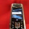 Vertu Signature S Mobile Phone. Stainless Steel with Studded Leather Back with Ceramic Pillow & Keypad, S/N S-0101**, IMEI 355711, Made 02.2010, Lifetimer 0180:24. Comes with Black Leather Signature S Phone Case (Used), 2 Batteries, Partial Sales Pack, Ch - 16