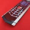 Vertu Signature S Mobile Phone. Stainless Steel with Orange Encrusted Stone Pillow & Black Studded Leather Back. S/N S-0937**, IMEI 355711, Made 12.2013, Lifetimer 0004:14. Comes with Partial Sales Pack, 2 Batteries, Charging Adaptors & Leads. (Note this - 2