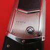 Vertu Signature S Mobile Phone. Stainless Steel with Orange Encrusted Stone Pillow & Black Studded Leather Back. S/N S-0937**, IMEI 355711, Made 12.2013, Lifetimer 0004:14. Comes with Partial Sales Pack, 2 Batteries, Charging Adaptors & Leads. (Note this - 7