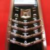 Vertu Signature S Mobile Phone. Stainless Steel with Tutti Frutti Diamonds, Sapphires & Emerald Encrusted Pillow with Black Leather Studded Back. S/N S-01211**, IMEI 355711, DEMO, Made 09.2010 , Lifetimer 0000:00, with Russian Keypad. Comes with 2 Batteri - 13