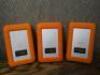 3 x Lacie Rugged Mini 1TB External HD's with Neil Poulton Design Orange Rubber Protector. - 4