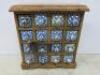 New/Boxed Namaste Spice Chest in Mango Wood with 16 Blue & Green Ceramic Drawers. Size H35 x W33 x D11cm.