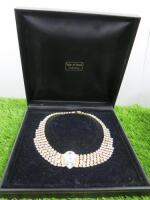 A Five to 2 Layer Clear Stone Dress Necklace with a Large Stone to the Centre on Gold Coloured Metal in Presentation Case. Case Marked Isle of Bute.