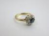 Diamond & Dark Centre Stone Set 9ct Yellow Gold Ring with White Gold Clasp. Stamped AL, 325 with Additional Stamps. 10 x Round Cut Diamonds & Centre 5mm Dark Stone. Comes with Ring Box. NOTE: Dk stone believed to be Sapphire but unchecked (sold as viewed - 5