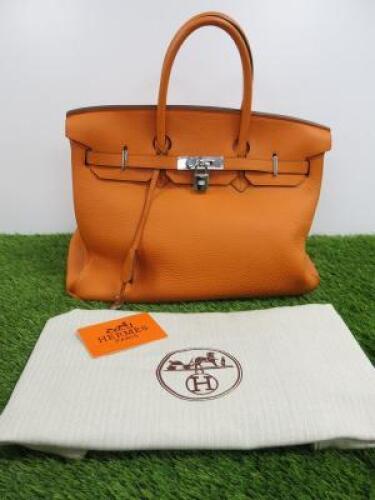 Clemence Orange Leather Birkin 35. Comes with Padlock, Key & Dust Cover.Note: We have had an expert look to Authenticate this bag, they have declared it to be a "Replica" with the following remarks.Reasons for Verdict:-Moulding of Edges Around BagStitchin