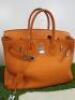 Clemence Orange Leather Birkin 35. Comes with Padlock, Key & Dust Cover.Note: We have had an expert look to Authenticate this bag, they have declared it to be a "Replica" with the following remarks.Reasons for Verdict:-Moulding of Edges Around BagStitchin - 3