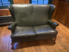 2 Seater High Back Green Faux Leather Settee with Stud Detail to Frame. Size H95 x W123 x D68cm.