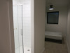 15.3m x 2.62m - Ex-Show Room Modular Housing Display Unit with Brick Front Finish, 2 Rendered Ends with Finish Required Top & Rear. Unit Sits on 2 x Sets of 6 Wheeled Galvanised Mobile Frames (7 x 3m). Fitted with Kitchen, Toilet, Shower room & Bedroom, A - 12