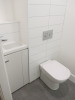 15.3m x 2.62m - Ex-Show Room Modular Housing Display Unit with Brick Front Finish, 2 Rendered Ends with Finish Required Top & Rear. Unit Sits on 2 x Sets of 6 Wheeled Galvanised Mobile Frames (7 x 3m). Fitted with Kitchen, Toilet, Shower room & Bedroom, A - 14
