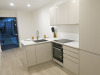 15.3m x 2.62m - Ex-Show Room Modular Housing Display Unit with Brick Front Finish, 2 Rendered Ends with Finish Required Top & Rear. Unit Sits on 2 x Sets of 6 Wheeled Galvanised Mobile Frames (7 x 3m). Fitted with Kitchen, Toilet, Shower room & Bedroom, A - 21
