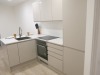 15.3m x 2.62m - Ex-Show Room Modular Housing Display Unit with Brick Front Finish, 2 Rendered Ends with Finish Required Top & Rear. Unit Sits on 2 x Sets of 6 Wheeled Galvanised Mobile Frames (7 x 3m). Fitted with Kitchen, Toilet, Shower room & Bedroom, A - 23