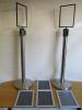 Pair of Metal Barrier Pavement Stands with 4 x A4 Clip Shut Frames.