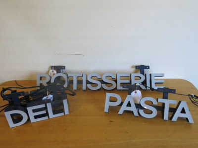 3 x LED Lit signs to Include: 1 x Double Sided Led Lit Deli Sign on Blue Metal Box Frame with 2 x LED Drivers. Size H11 x W31 x D15cm. 1 x Led Lit Pasta Sign with LED Driver, Size H11 x W47 x D6cm & 1 x Led Lit Rotisserie Sign, Size H11 x W86 X D10cm (