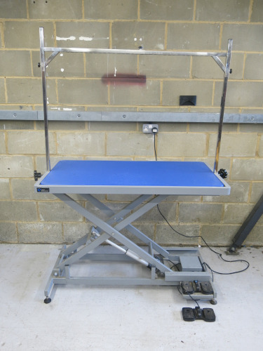 Groom Professional Dog Grooming Electric Raise & Lower X Frame. Comes with Blue Rubber Matting, Foot Pedals, Levellers for Stability & H-Bar. Size Length 126 x Width 65 x Height 27-91cm. Dog Capacity 120kg.