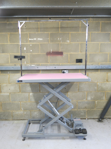 Groom Professional Dog Grooming Electric Raise & Lower X Frame. Comes with Pink Rubber Matting, Foot Pedals, Levellers for Stability & H-Bar. Size Length 126 x Width 65 x Height 33-116cm. Dog Capacity 120kg.