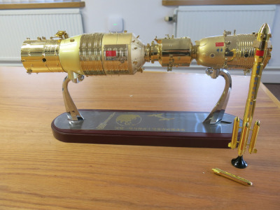 Gold Coloured 17" Model of Chinese Spacecraft, Mounted on Sliding Plinth 2 Show Coupling, with Additional Gold Coloured Metal Rocket Which Requires Minor Repair.