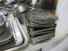 Large Quantity of Assorted Metal Kitchen Accessories to Include: Frying Pans, Sauce Pans, Baking Trays, Cream Chargers, Assorted Tools, etc ( As Viewed/Pictured). - 12