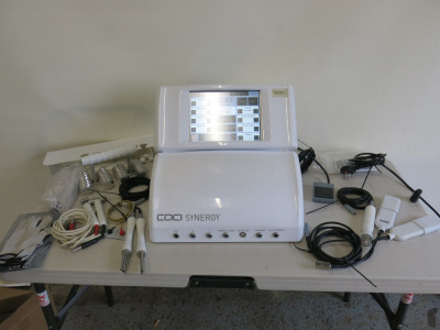 Caci Synergy Non Surgical Beauty Machine, S/N SYN984. Total Treatment Time 1010hrs. Comes with 8 Attachments to Include: Machine Probes, Wrinkle Combs, Roller, Hydra Tone Roller, Orbital Abrader, Foot Pedal Etc (As Viewed/Pictured)