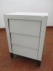 White Glass Covered, 3 Draw Bedside Cabinet on Wood Legs. Size H67 x W48 x D36cm.