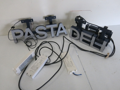 2 x LED Lit Signs to Include: 1 x Double Sided Led Lit Deli Sign on Blue Metal Box Frame with 2 x LED Drivers. Size H11 x W31 x D15cm & 1 x Led Lit Pasta Sign with LED Driver, Size H11 x W47 x D6cm.