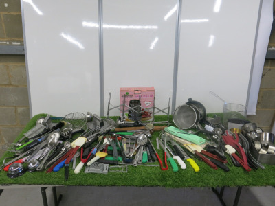 Large Quantity of Kitchen Accessories to Include: Sieves, Whisks, Graters, Spoons, Ladels, Tongs, Spatulas, Cookie Cutters, Mandolins, Boiled Egg Cutter, Can Opener, Cutter, Rolling Pin, Cake Moulds, Knives, Knife Sharpener & Mouse Rings (As Viewed/Pictur