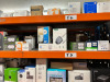 14 x Shelves of Assorted Smart & General Electricals to Include: PC & Laptop Headsets, Webcams, Meters, Readers, Monitors, Amp, Chargers, Testers, Fire Alarms, Door Bells, Lights, Plugs, Phones, Dash Cam Recorder, Radio, DVD Player, Wi-Fi Power Sockets, G - 13