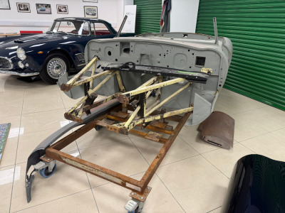 E-Type S1 Body Tub with Assorted Panel Parts to Include: 2 x Right Rear Wings, 1 x FR Wing & 2 x Doors. Comes on Mobile Jig.