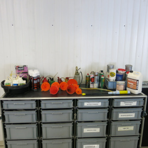 Crate Containing an Assortment of Drip Trays, Oil Cans, Degreaser, Grease, Funnels & Adhesive (As Viewed).