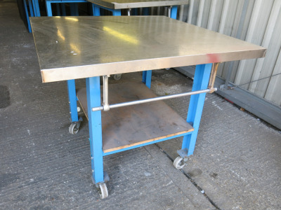 Mobile Height Adjustable Metal Framed Wood Top Workshop Table in Blue with Stainless Steel Top, Shelf Under & Paper Roll Holder on Side. Size W102 x D112cm
