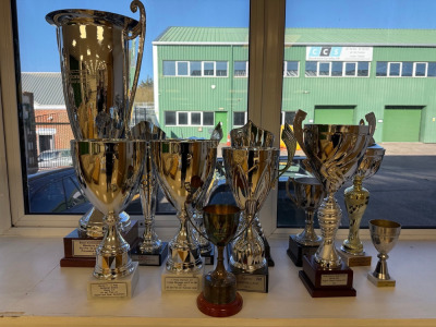 12 Assorted Trophies including a Stirling Moss Trophy from 2013, Motor racing Legends, RACSilverstone Classic. & Others.
