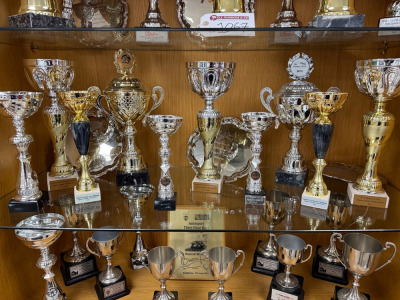 11 x Assorted Trophies, (Bottom Shelf of Trophy Cabinet, Not Included) Including: Thruxton, Donnington, Brands Hatch.