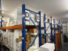 Approx 30 Bays or Boltless Racking in Orange & Blue to Include: 34 x Uprights (260cm x 90cm), 88 x Crossbeams (270cm) & 44 x Assorted Wood & Slate Shelves. NOTE: located London, E9, buyer to view & collect by appointment only and supply sufficient labour - 3