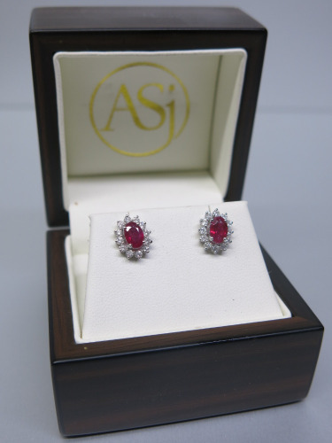 Pair of 18ct White Gold Earrings with Oval Ruby Stone Stud & Diamond Cluster Surround (0.5ct) in Box. RRP &pound;1425. NOTE: missing 1 x clasp.