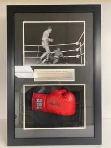 Sir Henry Cooper Signed Boxing Glove in Presentation Case with Image of Henry Cooper Knocking Down Cassius Clay (Muhammed Ali). Comes with Sprit of Sport Certificate of Authenticity Reference 5266. Size 53 x 79cm.