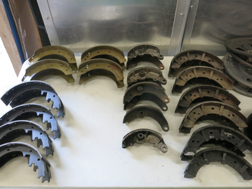 Crate Containing 16 x Pairs of Brake Shoes (As Viewed), 17 x Brake Drum Back Plates. NOTE: all appear to be for Jaguar models.