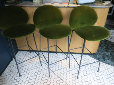 6 x Saba Ola Italian Made Green Velvet Upholstered Bar Stools on Black Metal Base. Size 76cm. NOTE: 2 x appear bleach stain (As Viewed/Pictured).