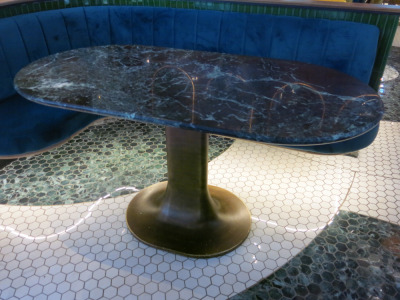 Green Alpi Oval Marble Top Restaurant Table with Burnished Brass Metal Tulip Pedestal Base, Size H75 x W145 x D75cm.