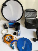 Zip Up Carrier with Assorted Camera Accessories, Including Nikon Flash and Nikon D200 Battery Grip.