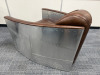 Timothy Oulton Aviator Tomcat Chairs in Brown Leather & Spitfire Design. Product Description from Website: Taking inspiration from the legendary British fighter plane, the innovative Aviator Tomcat is modelled on the twin cockpit chair of the American F-1 - 4